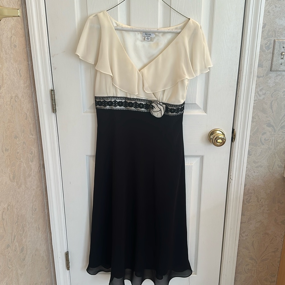Black and cream dress with shimmer ruffled sleeves. Size 6.
